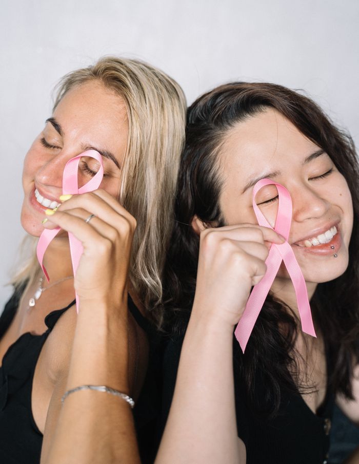2-women-holding-pink-ribbons-5482982 Two women holding pink ribbons, symbolizing breast cancer awareness and solidarity.