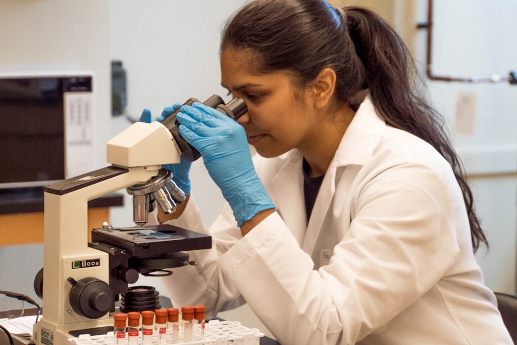 woman-looking-on-microscope-inside-room-6q5qg8iigro Observing samples under the microscope